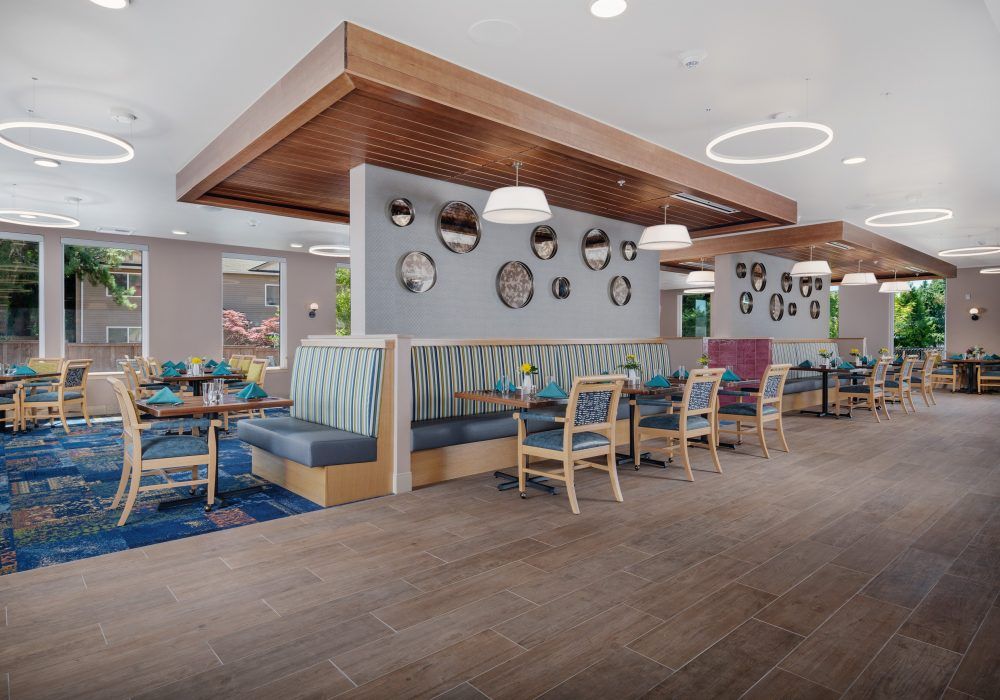 A modern restaurant interior featuring booth seating and contemporary wall art.