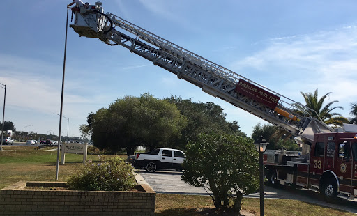 A fire truck extends its ladder towards the sky, ready for action.