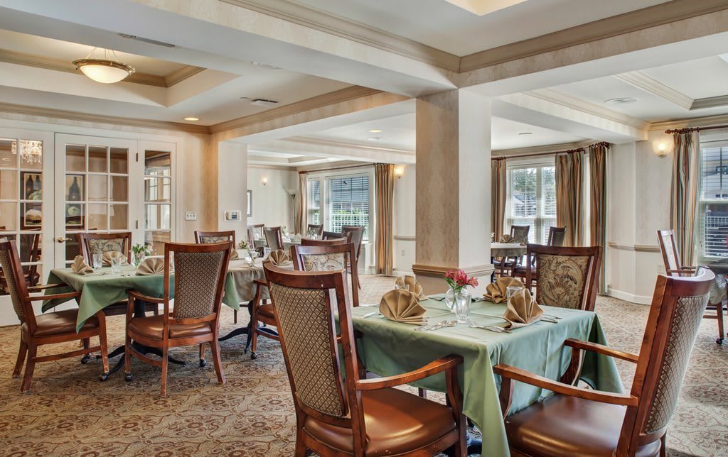 An elegant dining room with neatly arranged tables and chairs.
