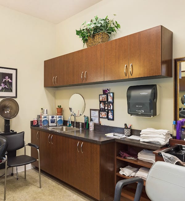 A well-equipped salon interior with hair care products and comfortable seating.