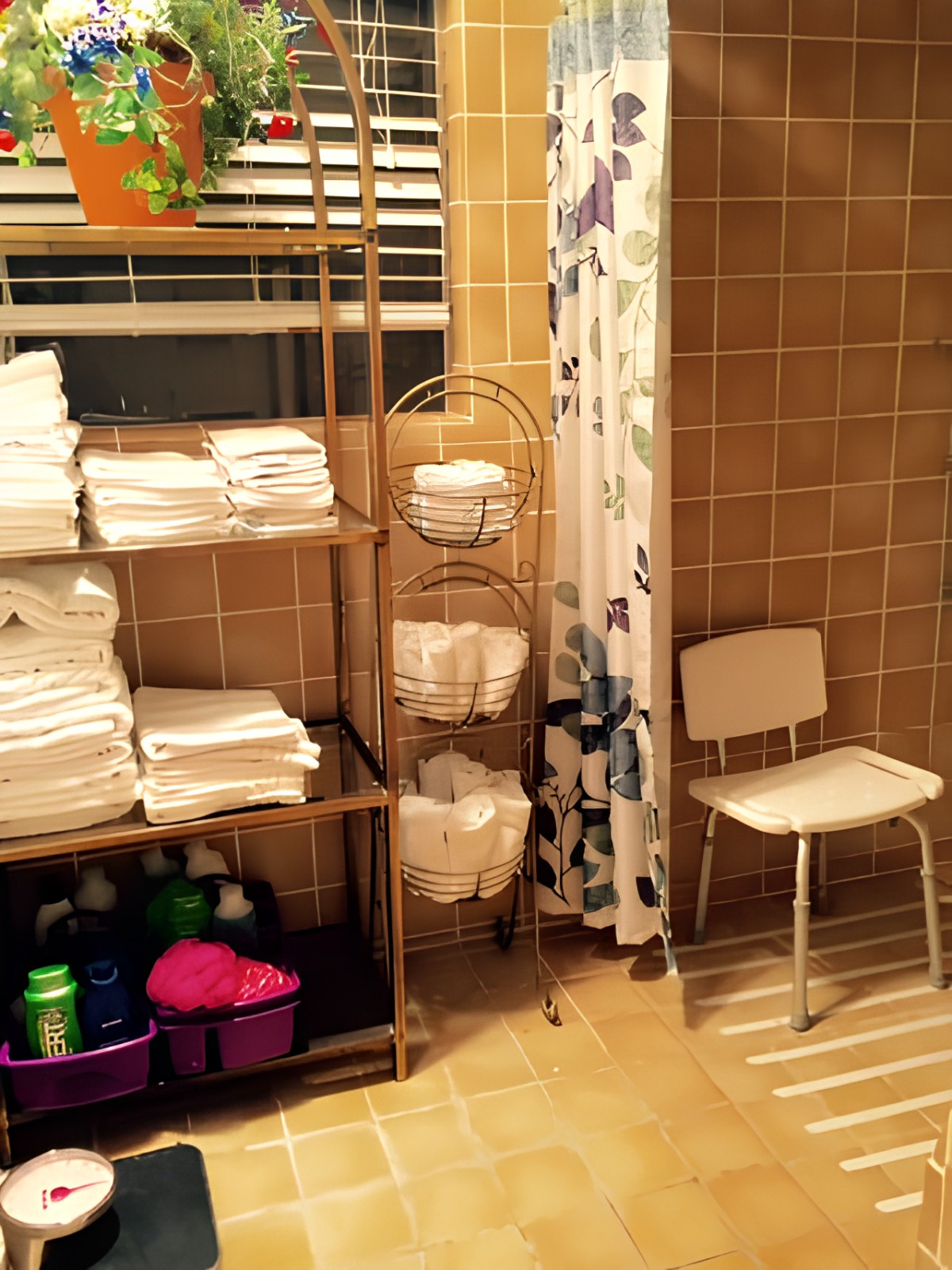 Well-organized bathroom with shelves of neatly folded towels and supplies.