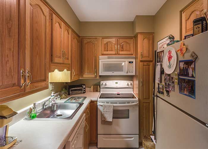 A cozy kitchen with wooden cabinets and modern appliances.