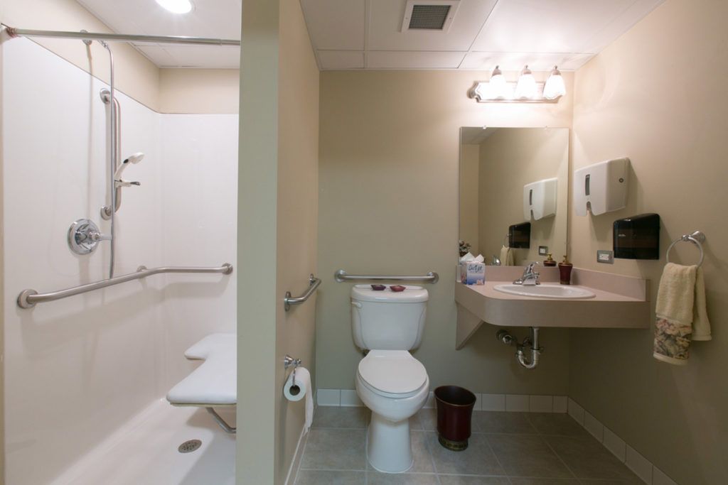 A modern bathroom with a shower, toilet, and sink area.