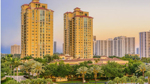 A captivating view of urban towers surrounded by lush greenery at sunset.