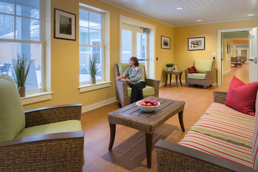 A cozy living room with natural lighting and comfortable seating arrangements.