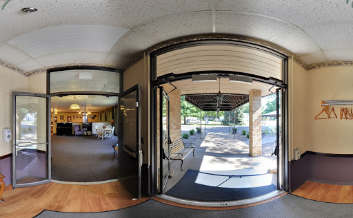 A panoramic view of an entrance leading to an outdoor area, showcasing the transition from indoors to outdoors.