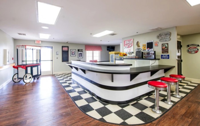 A retro-style diner featuring a classic checkerboard floor and vintage decor.