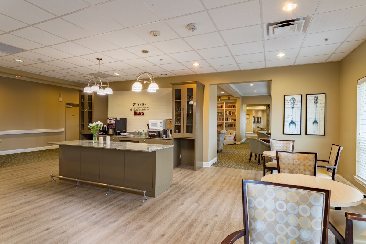 A modern kitchen and dining area with contemporary furnishings and lighting.