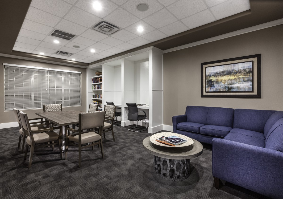 A modern office space featuring a conference table and a comfortable seating area.