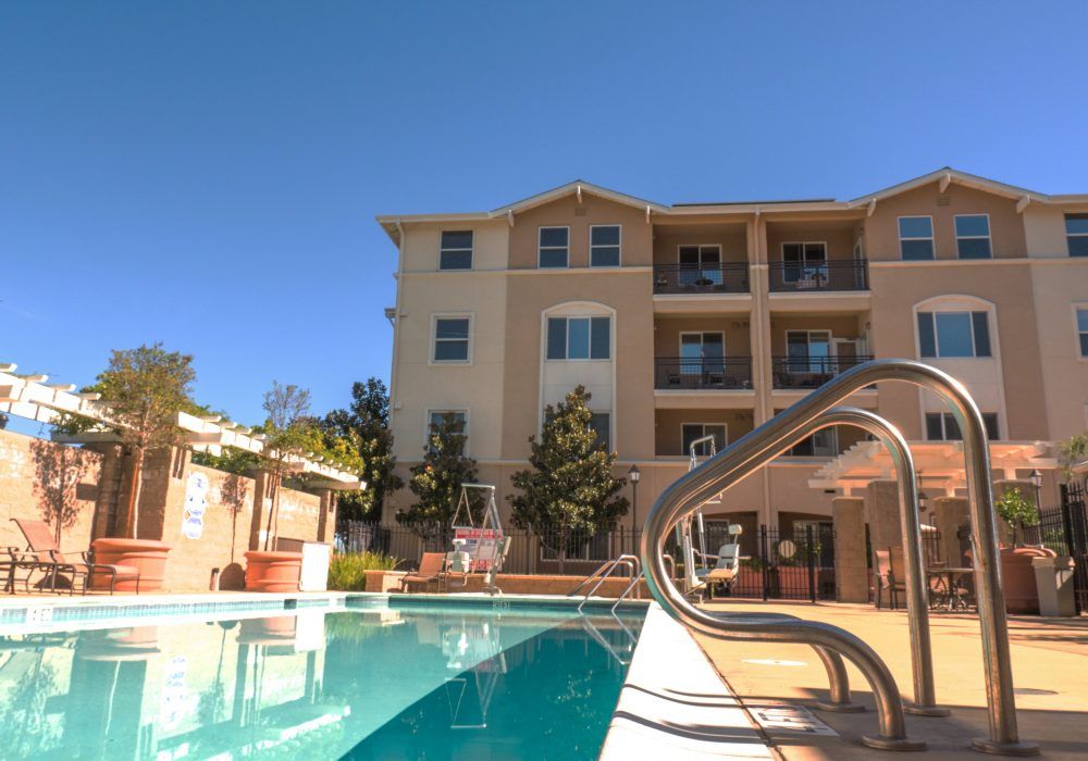 A residential apartment building with an outdoor swimming pool.