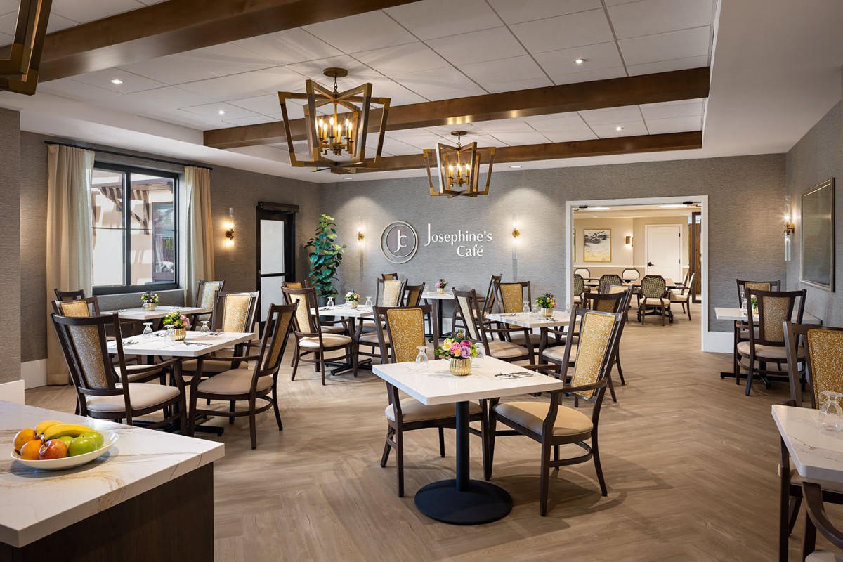 A modern and stylish restaurant dining room with neatly arranged tables and chairs.