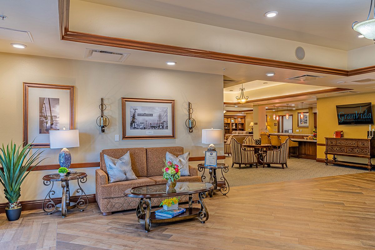 A cozy living room interior with a sofa, coffee table, and warm lighting.