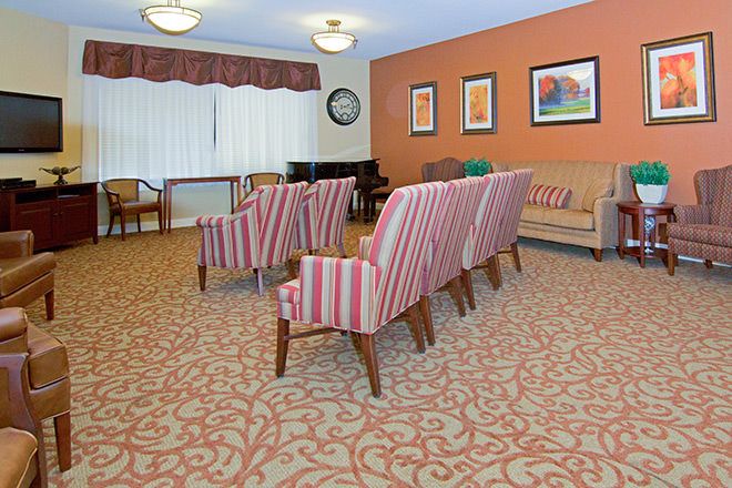 A cozy lounge area with striped chairs and warm decor.
