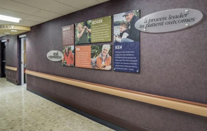 A hospital hallway featuring informational posters and wall art.