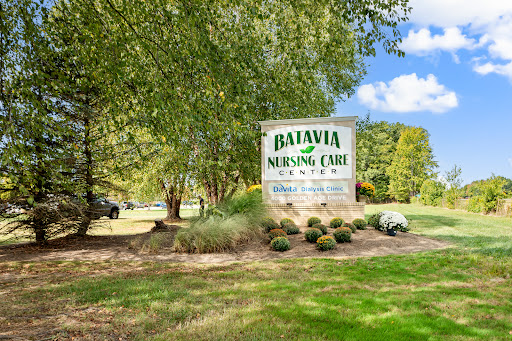Entrance sign of Batavia Nursing Care surrounded by greenery.