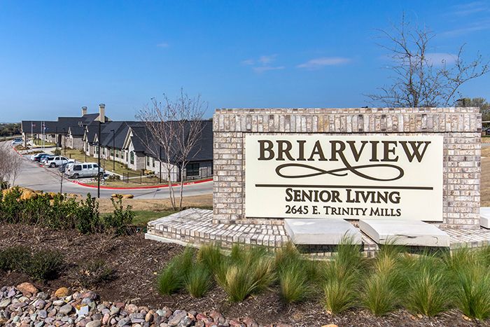 Entrance sign for Briarview Senior Living with building and landscaping in the background.