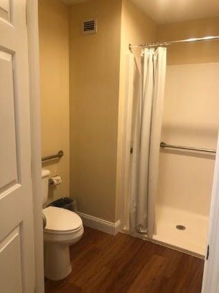 An accessible bathroom with a shower and toilet.