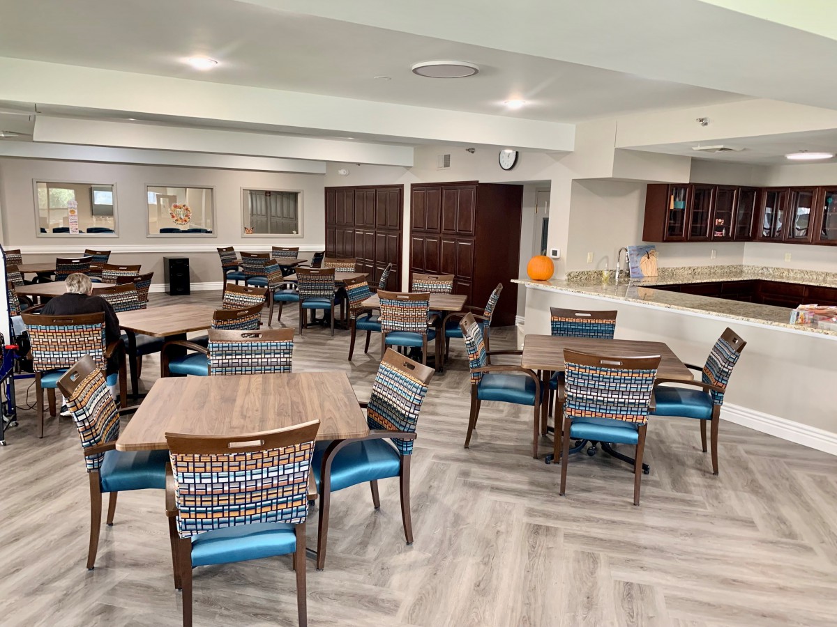 A modern dining area with neatly arranged tables and chairs.