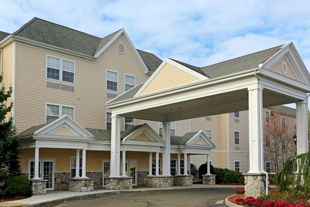 A modern hotel exterior featuring a covered entrance.