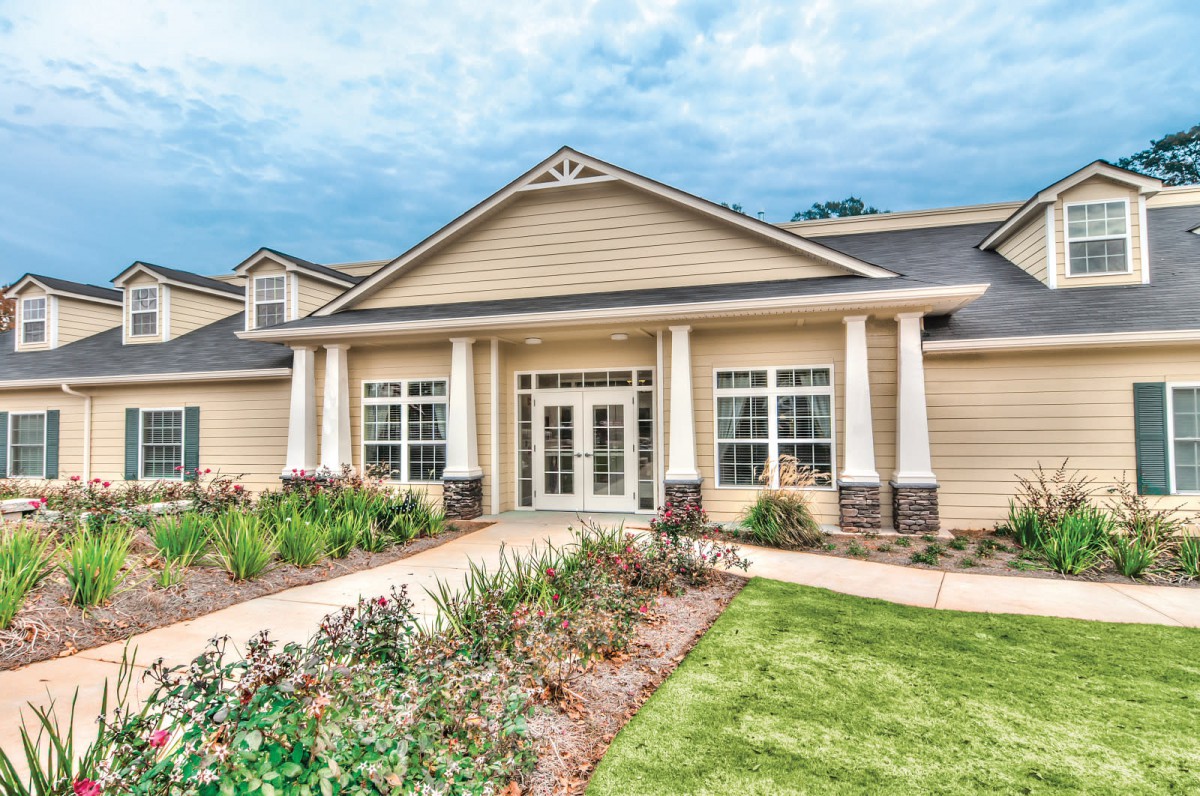 A beautiful house with a landscaped garden and classic architectural features.