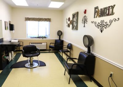 A cozy salon interior with hairstyling chairs and hair dryers.