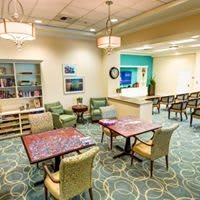 A well-furnished waiting area with comfortable seating and a welcoming reception desk.