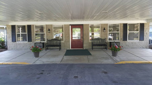 A welcoming entrance with benches and planters along the pathway.