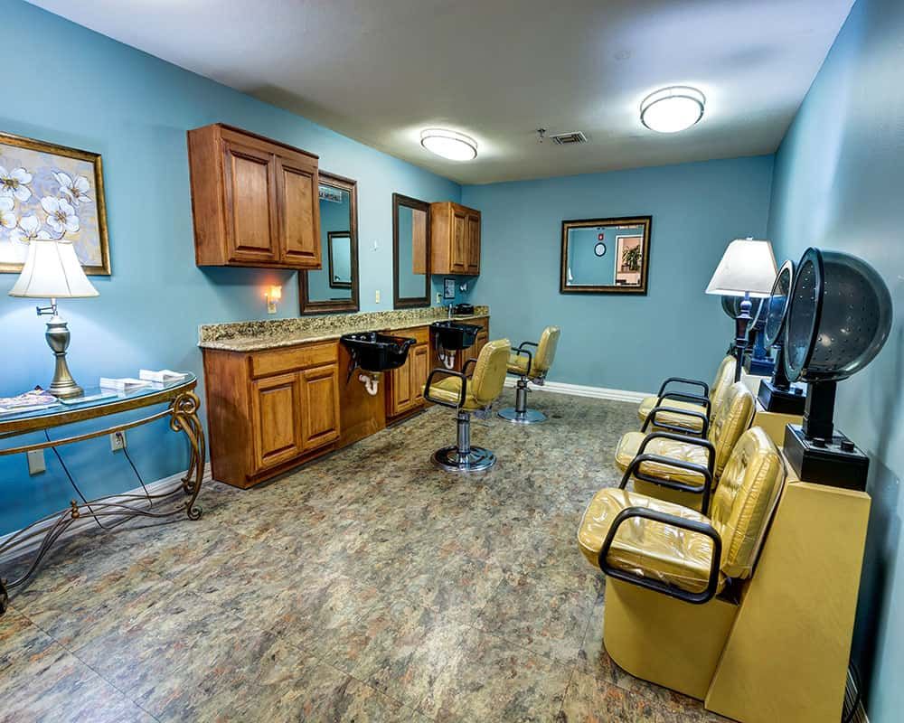A modern hair salon interior featuring comfortable chairs, mirrors, and wooden cabinets with a sleek design.
