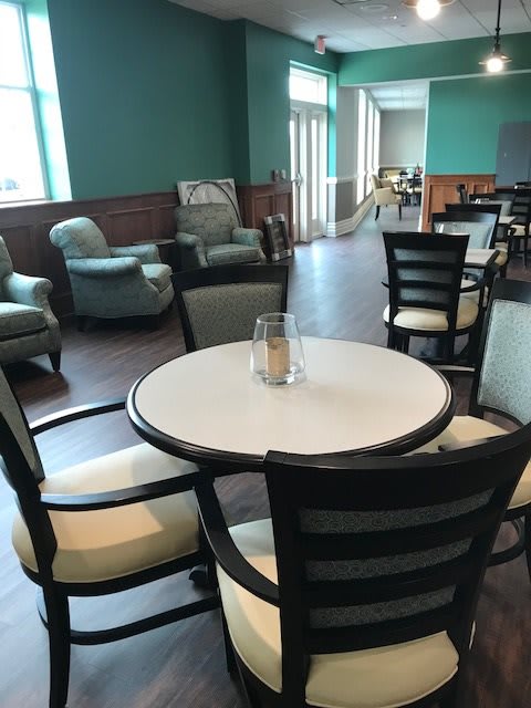 A comfortable lounge area with tables and chairs arranged in an inviting setting.