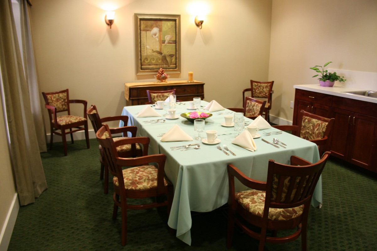 A formal dining room setup with a large table, chairs, and elegant decor.