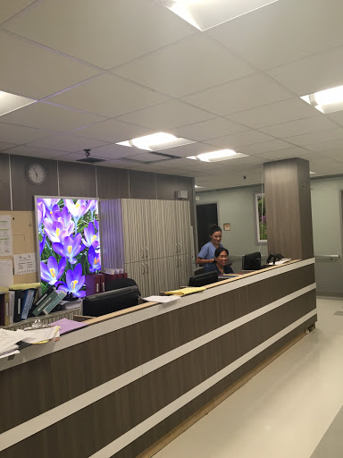 A modern office reception area with staff attending to visitors.