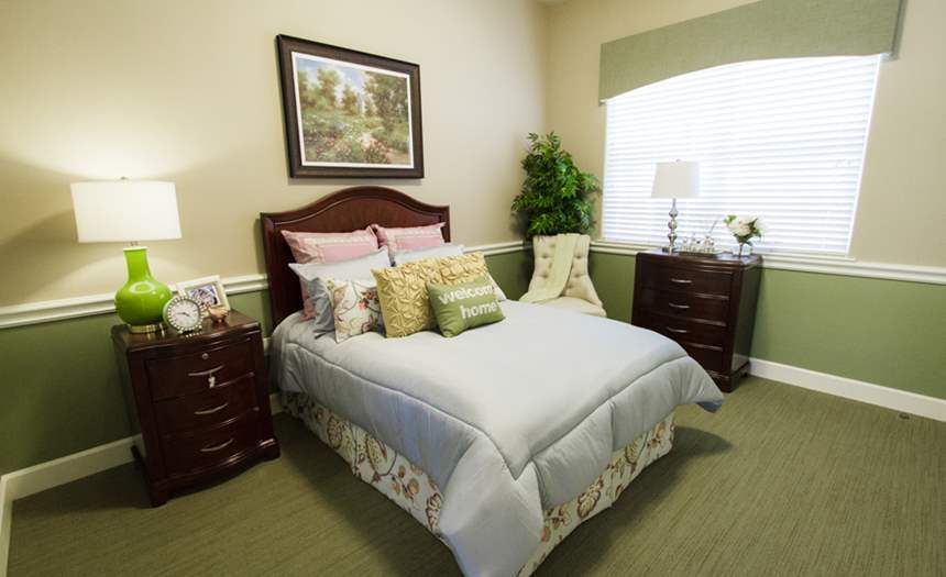 A cozy bedroom with a neatly made bed and stylish decor.