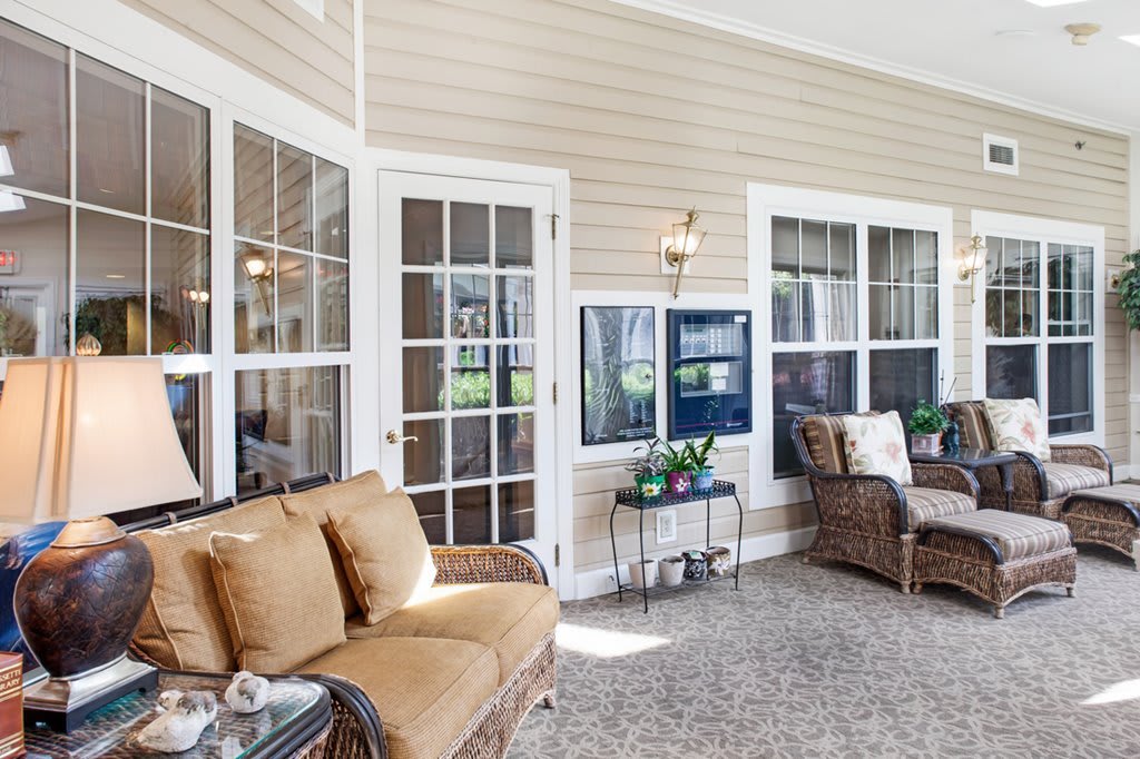 A bright and inviting sunroom with comfortable seating and large windows.