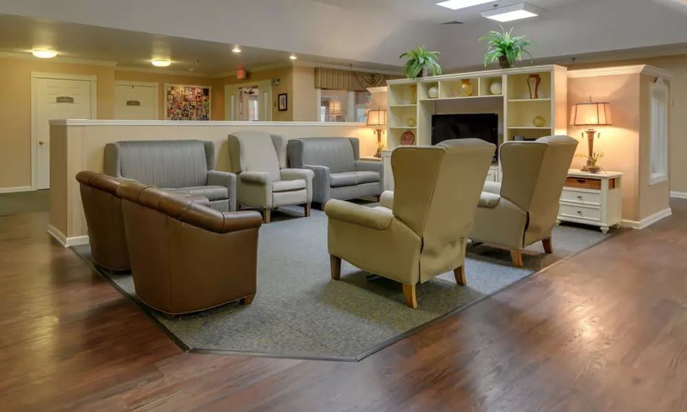 A cozy living room with comfortable seating and bookshelves.