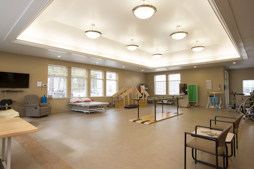 A spacious rehabilitation therapy room equipped for patient exercises and recovery.