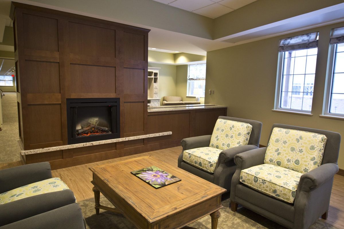 A cozy living room with a fireplace and comfortable seating arrangement.