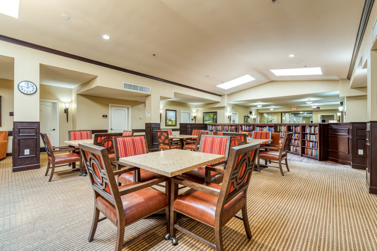 An empty dining area with neatly arranged tables and chairs.