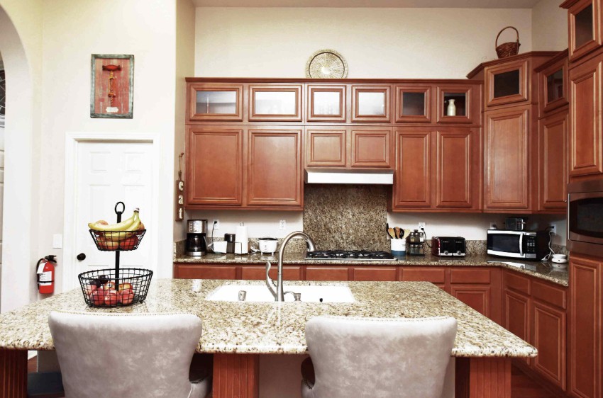Modern kitchen with wooden cabinets and a granite countertop.