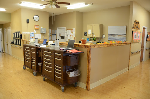 A well-organized medical office reception area with cabinets and computers.