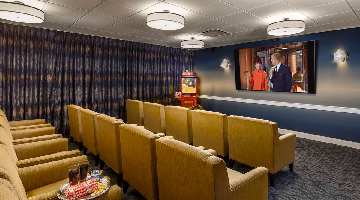 A cozy home theater with comfortable seating and a large screen.