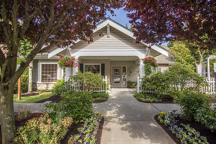 A charming house with a well-maintained front yard and beautiful landscaping.