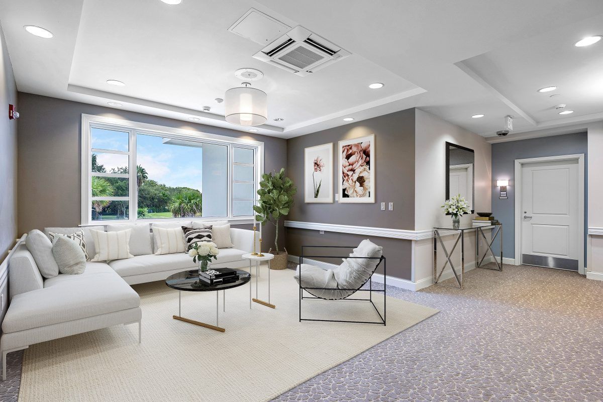 A modern living room with stylish furniture and large windows.