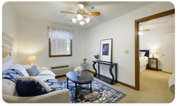 A cozy living room with a sofa, coffee table, and decorative artwork.