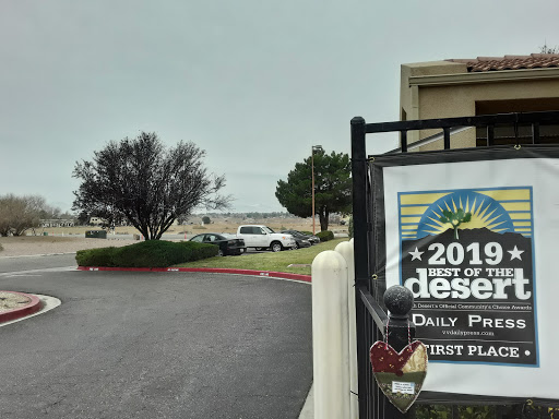 A view of a desert area with cloudy skies and a sign indicating the year.