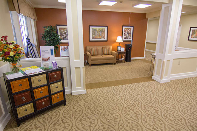 A cozy waiting area with a sofa and warm decor.