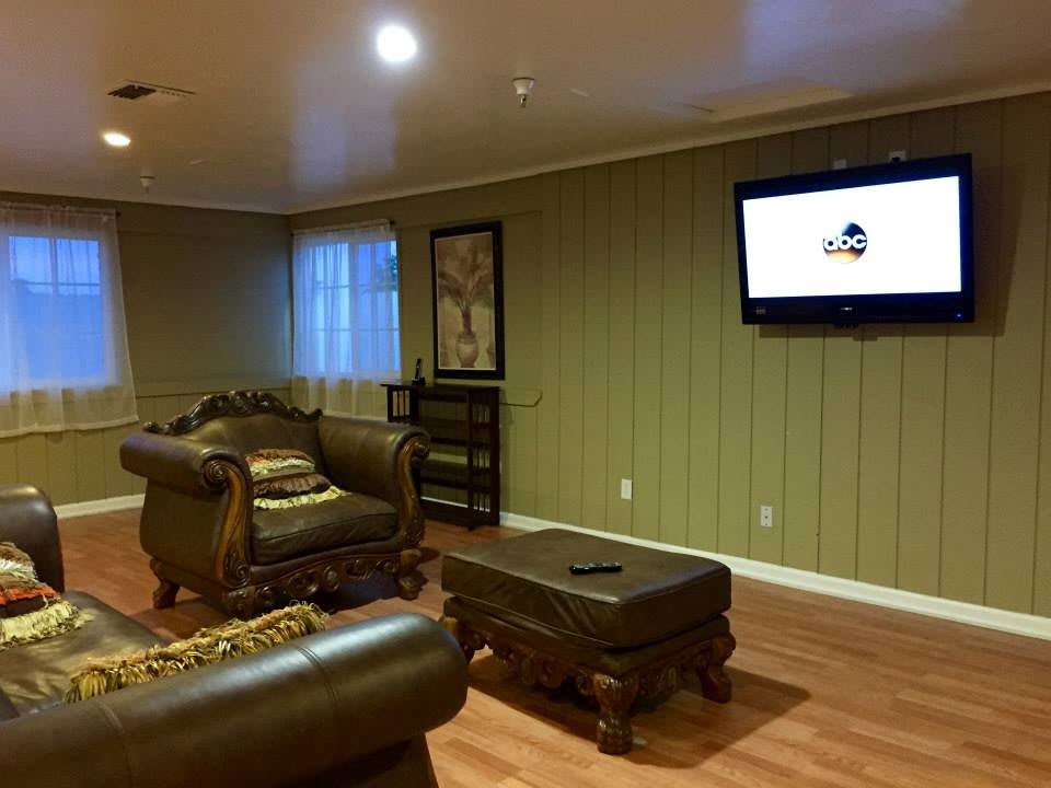 A cozy living room with comfortable seating, a wall-mounted television, and stylish decor.