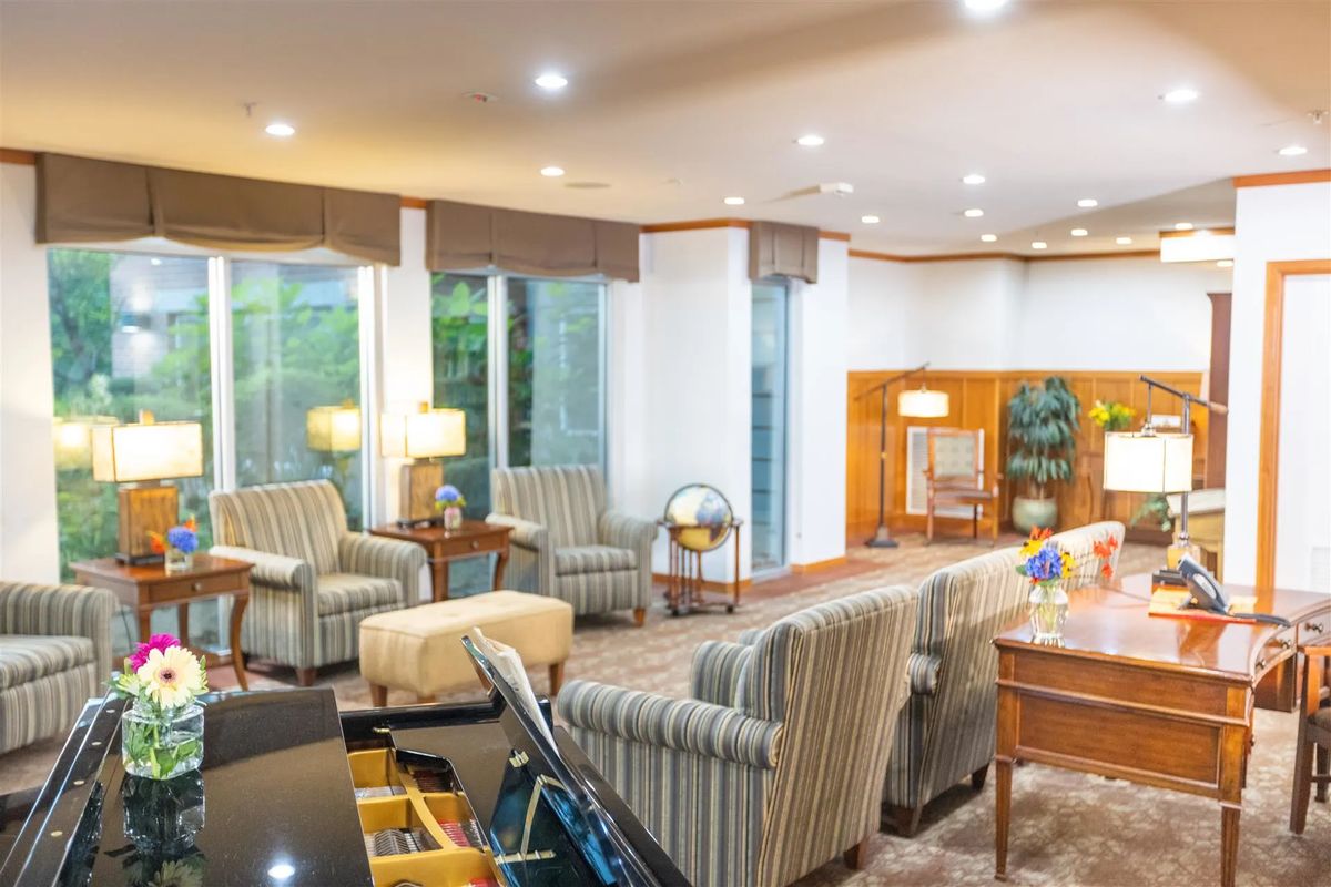 A spacious living room with comfortable seating and elegant decor.