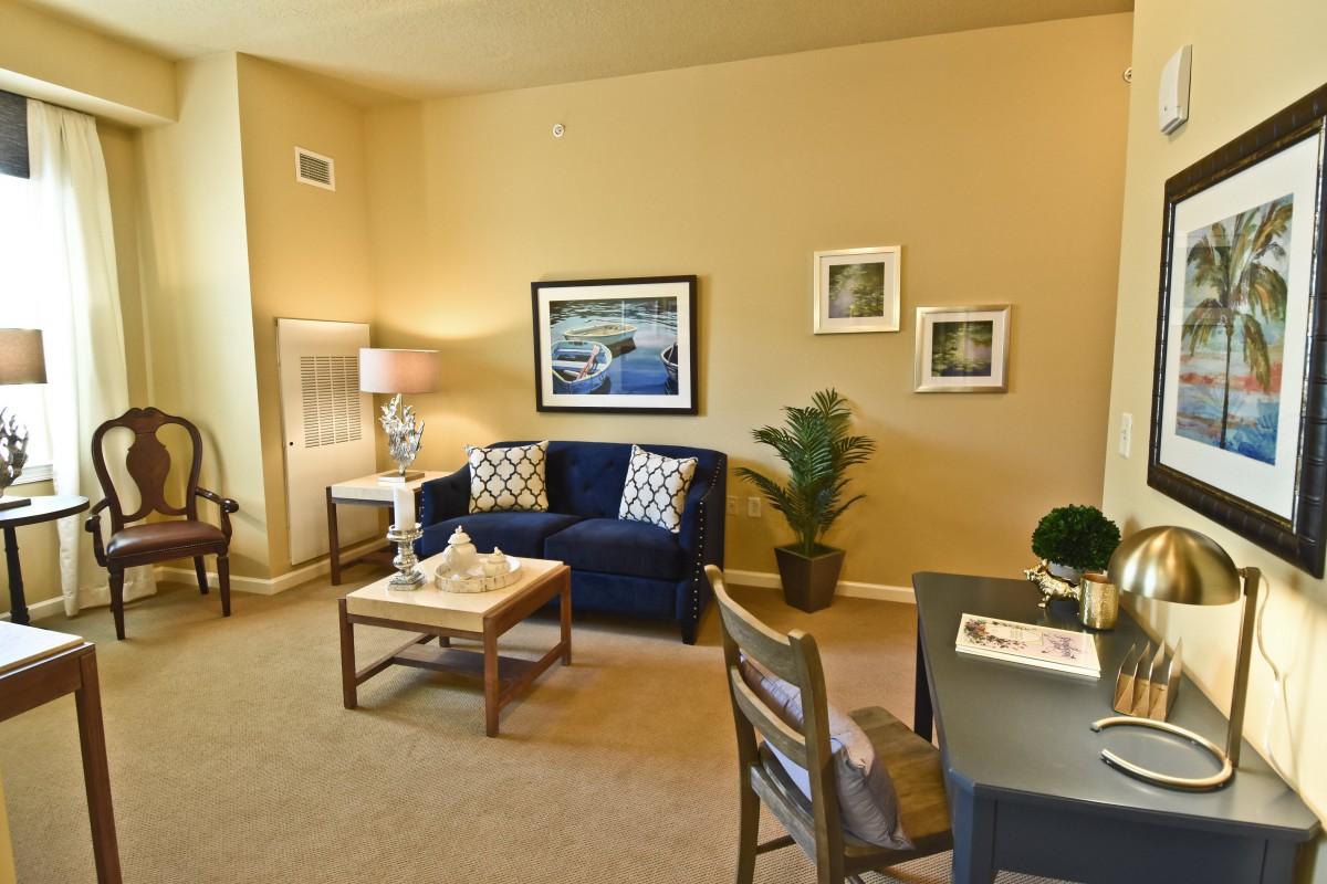 A cozy living room with a sofa, coffee table, and stylish decor.
