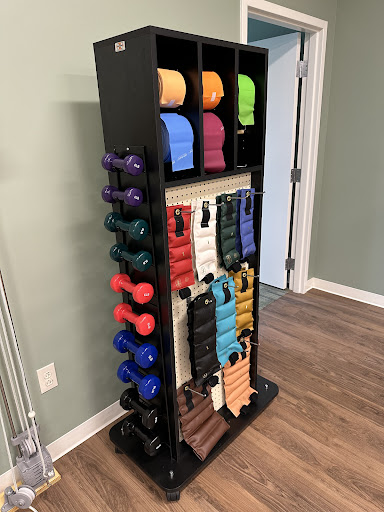A well-organized fitness rack displaying various dumbbells and resistance bands, perfect for a home gym setup.
