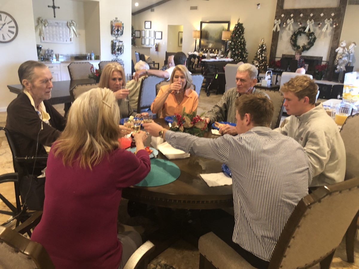 A group of people sitting around a dining table, enjoying a social gathering.